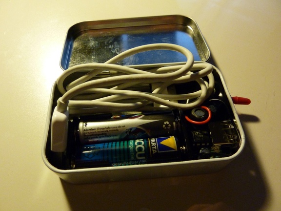 MintyBoost: The original (Apple iPhone USB) cable fits inside even though it's still a bit too bulky. Ordered a shorter version of the cable which shd easily fit into this box.